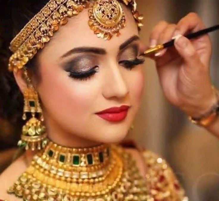 Professional bridal makeup by Looks Mantra - Traditional Indian bridal look with gold jewelry
